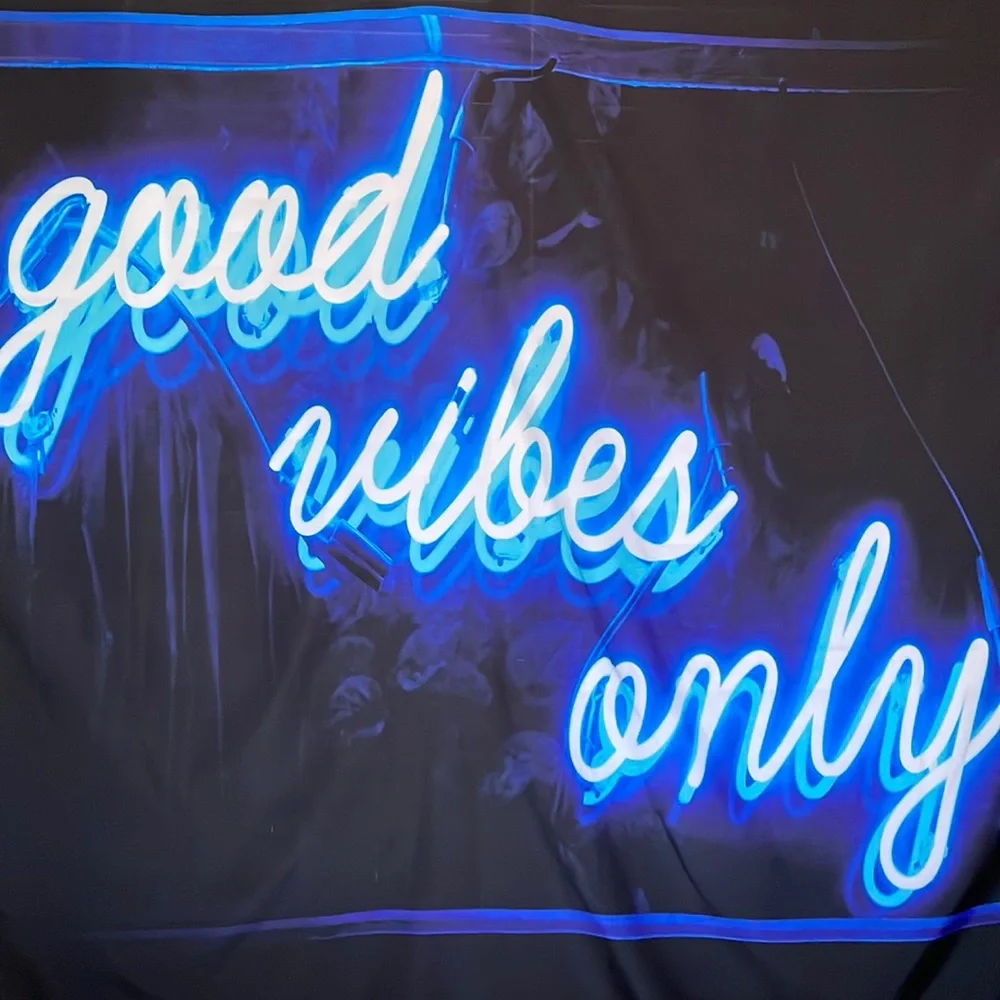 Black Tapestry with Blue Letters Graphic.